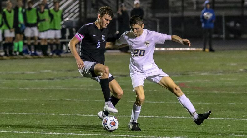 Monroe High School junior Adam Ploeger (right) and Cincinnati Wyoming’s Jesse Levine tussle for the ball during their Division II regional semifinal match on Wednesday night at Lakota East High School. Wyoming won 1-0. CONTRIBUTED PHOTO BY MICHAEL COOPER