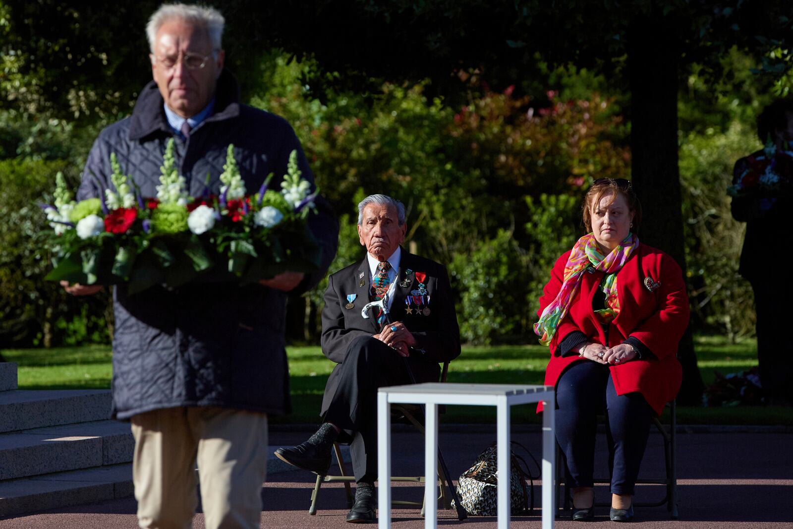 World War II D-Day veteran and Penobscot Elder from Maine, Charles Norman Shay, center, and Marie Pacale Legrand during a D-Day 76th anniversary ceremony at the Normandy American Cemetery in Colleville-sur-Mer, Normandy, France, June 6, 2020. (AP Photo/Virginia Mayo)