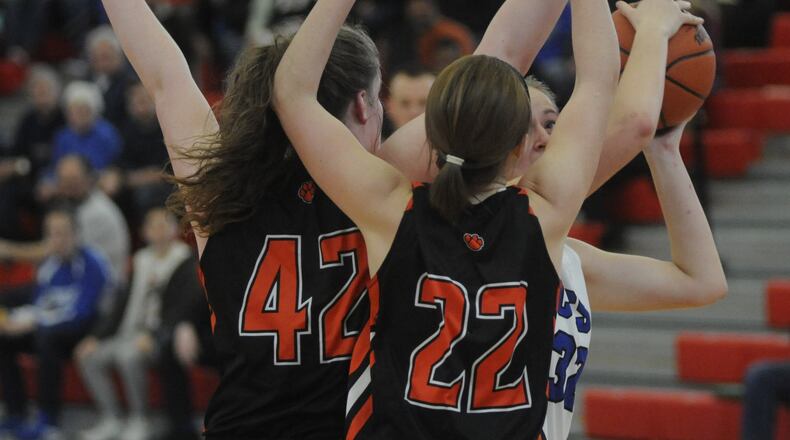 Cincinnati Christian’s Grace Edmonston (with ball) has her path blocked by Jackson Center defenders during a Division IV district final at Troy on March 4, 2017. MARC PENDLETON/STAFF