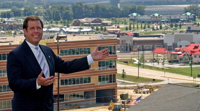 In this 2005 file photo, Joe Hinson, the West Chester-Liberty Chamber of Commerce CEO, stands with open arms in front of a still young yet booming Union Centre Boulevard. The West Chester interchange turns 20 this year. STAFF FILE/2005