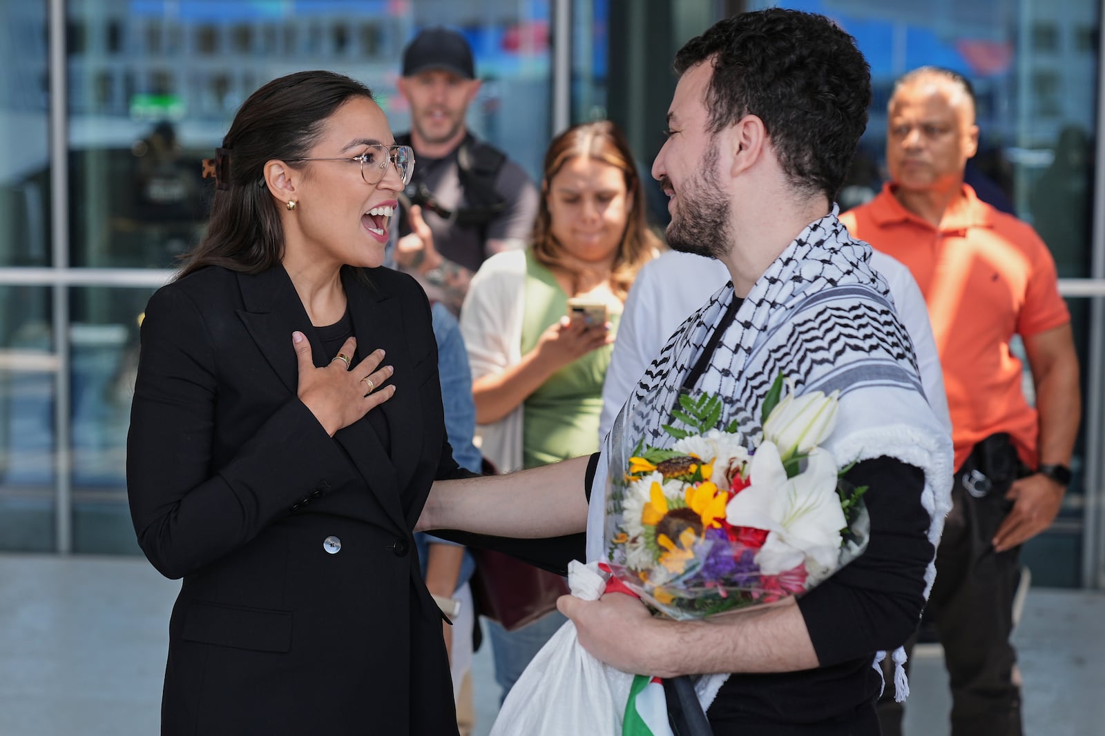Mahmoud Khalil, right, speaks to Rep. Alexandria Ocasio-Cortez, D-N.Y., after arriving at Newark International Airport, Saturday, June 21, 2025, in Newark, N.J. (AP Photo/Seth Wenig)