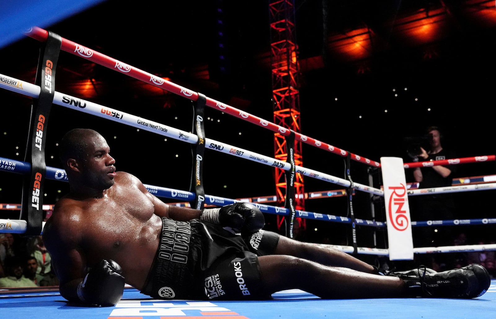 Daniel Dubois lies on the ring after a knockout by Ukraine's Oleksandr Usyk during their world heavyweight boxing title fight, in London, Saturday, July 19, 2025. (Bradley Collyer/PA via AP)