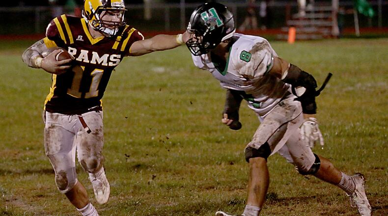 Ross quarterback Zach Arno tries to avoid Harrison defensive back Bailey Smith during their game at Ross on Friday night. CONTRIBUTED PHOTO BY E.L. HUBBARD