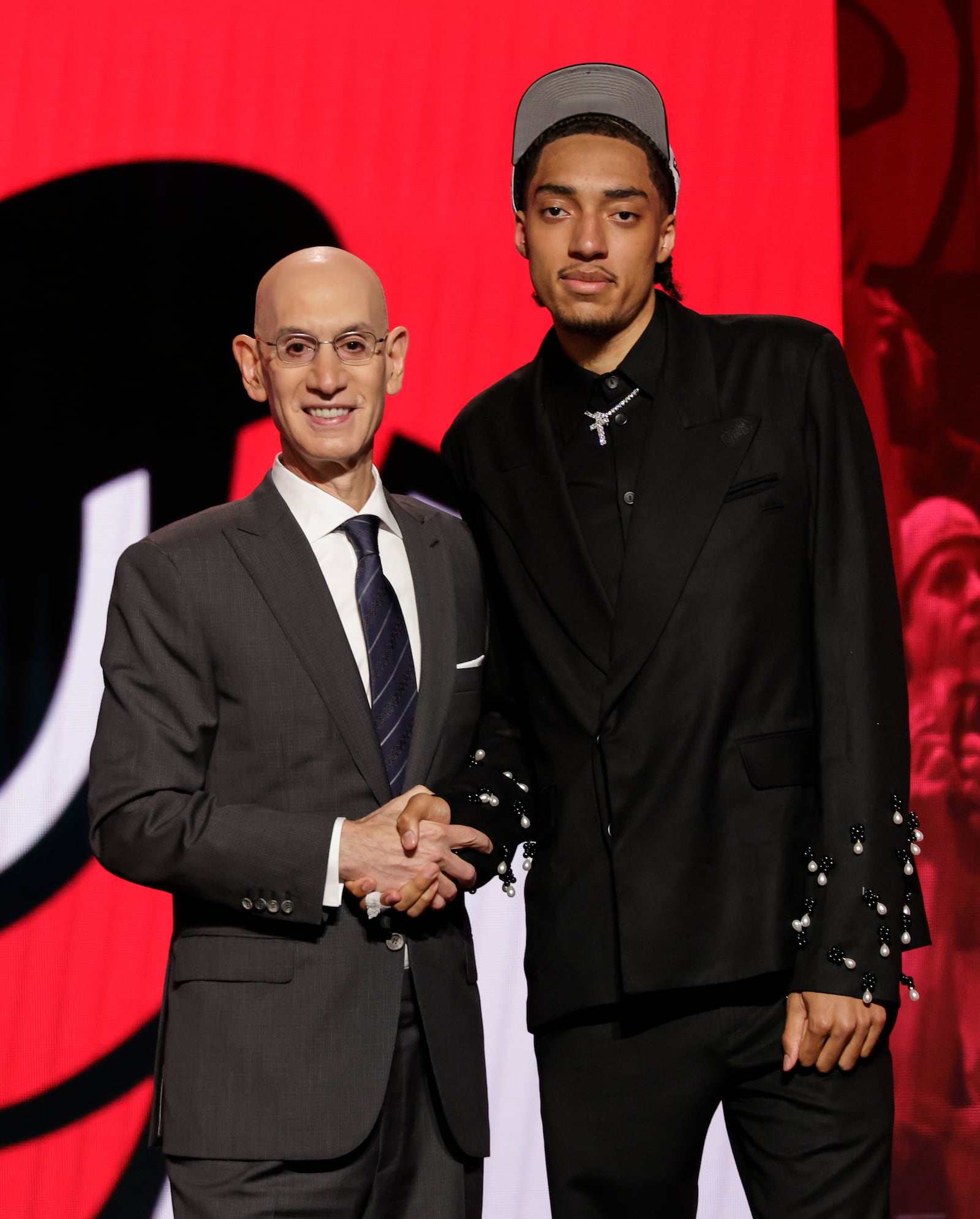 Noa Essengue poses for a photo with NBA commissioner Adam Silver after being selected 12th by the Chicago Bulls in the first round of the NBA basketball draft, Wednesday, June 25, 2025, in New York. (AP Photo/Adam Hunger)
