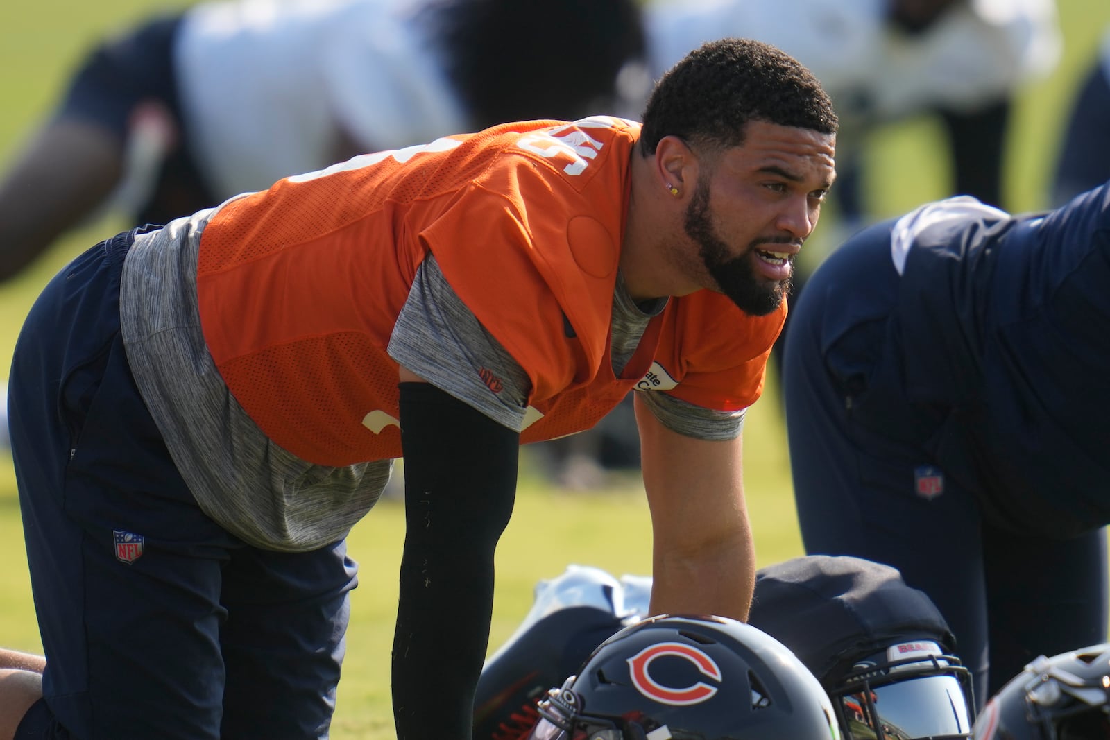 Chicago Bears quarterback Caleb Williams (18) stretches during practice at NFL football training camp, Wednesday, July 23, 2025, in Lake Forest, Ill. (AP Photo/Erin Hooley)