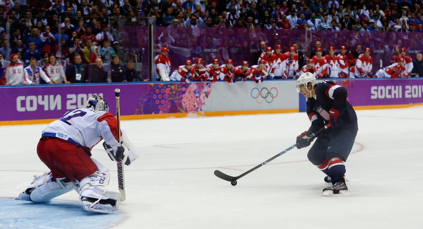 FILE - USA forward T.J. Oshie prepares to take a shot against Russia goaltender Sergei Bobrovski in an overtime shootout during a men's ice hockey game at the 2014 Winter Olympics, Saturday, Feb. 15, 2014, in Sochi, Russia. Oshie scored the winning goal and the USA won 3-2. (AP Photo/Julio Cortez, File)