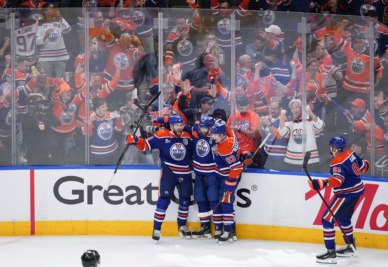 Edmonton Oilers' Leon Draisaitl, from left to right, Evan Bouchard, Ryan Nugent-Hopkins and Evander Kane celebrate Draisaitl's winning goal during the first overtime period in Game 1 of the NHL Stanley Cup Final against the Florida Panthers, in Edmonton, Alberta, on Wednesday, June 4, 2025. (Darryl Dyck/The Canadian Press via AP)
