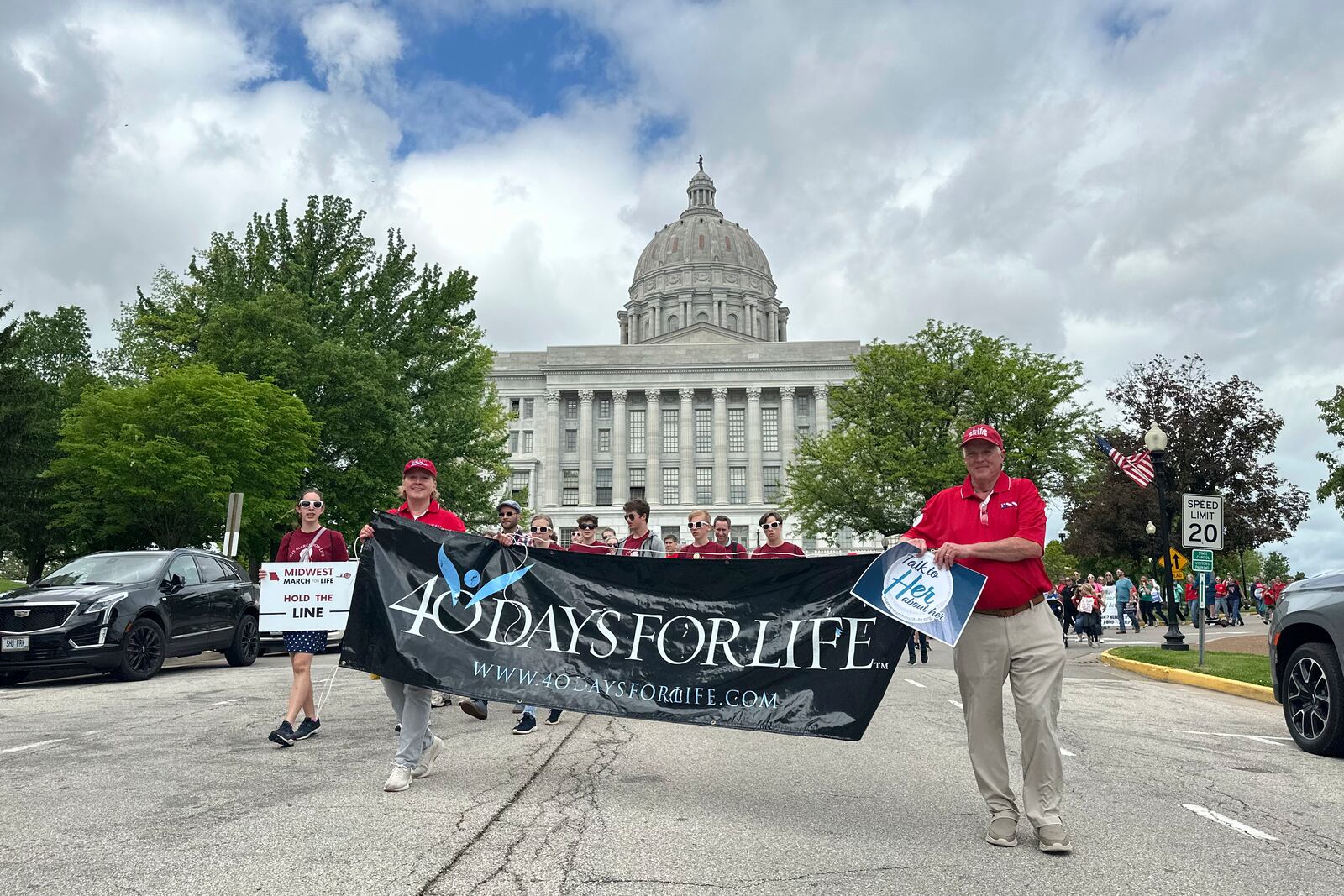 Participants in the Midwest March for Life walk through the streets of Jefferson City, Mo., with the state Capitol in the background on May 1, 2025. (AP Photo/David A. Lieb)