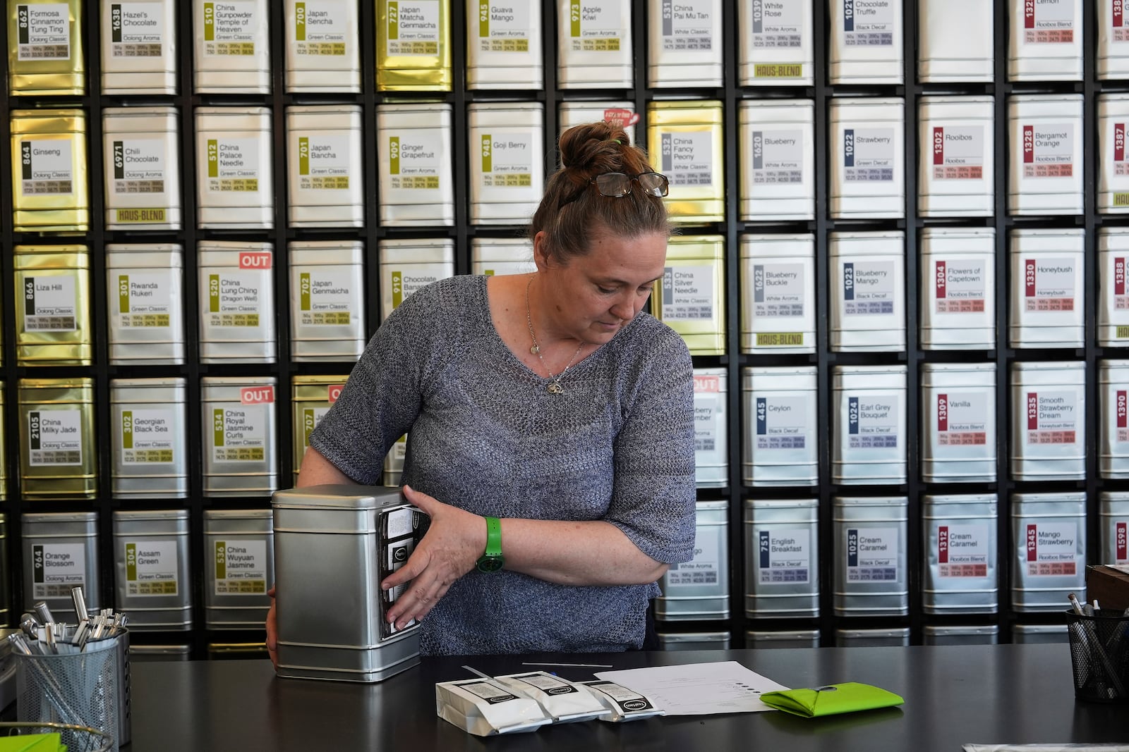 Owner Lisa McDonald packages a loose leaf tea orders at the TeaHaus Thursday, April 24, 2025, in Ann Arbor, Mich. (AP Photo/Paul Sancya)
