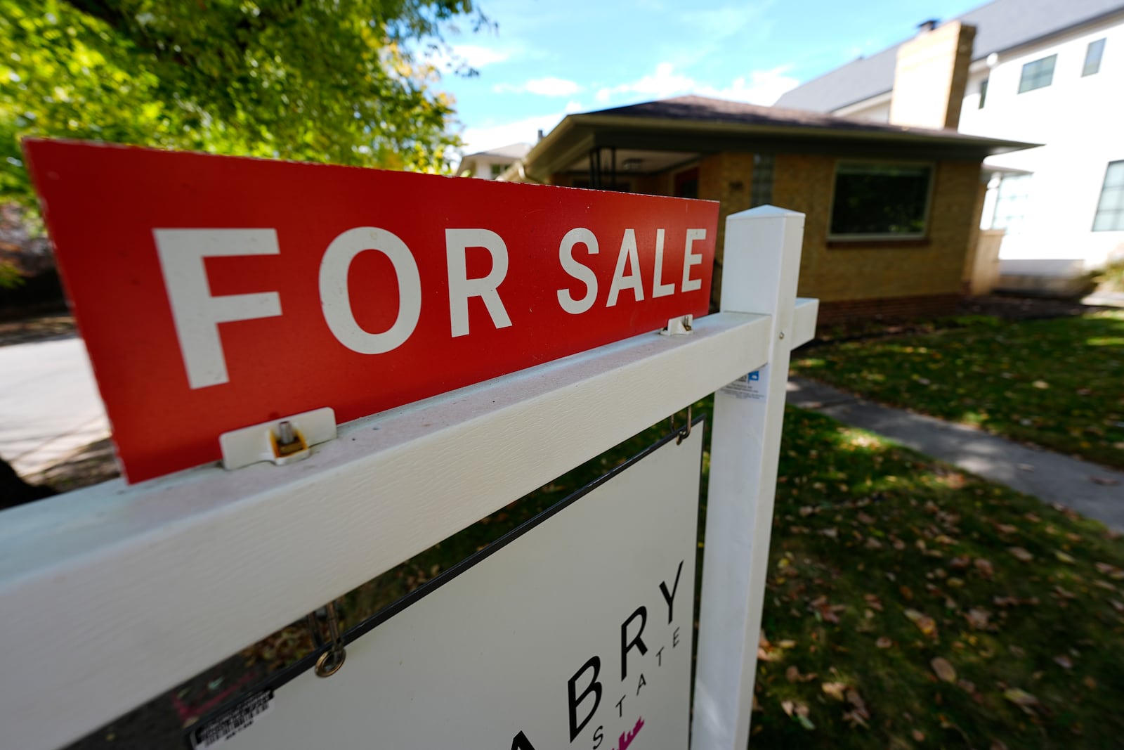 FILE - A sale sign stands outside a home on the market Thursday, Oct. 17, 2024, in the east Washington Park neighborhood of Denver. (AP Photo/David Zalubowski, File)