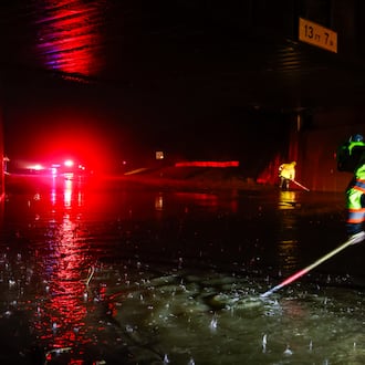 Dustin Carpenter from Ohio Department of Transportation works to clear drains on a flooded Germantown Road early Thursday morning, March 5, 2026 in Madison Township in Butler County. Heavy rain caused flooding in many areas. NICK GRAHAM/STAFF