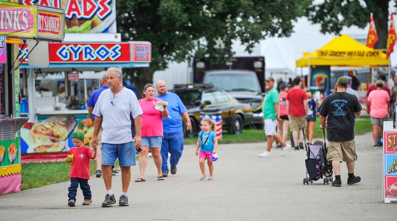 Fairgoers walk through the food vendor area at the Butler County Fair Monday, July 23 in Hamilton. NICK GRAHAM/STAFF