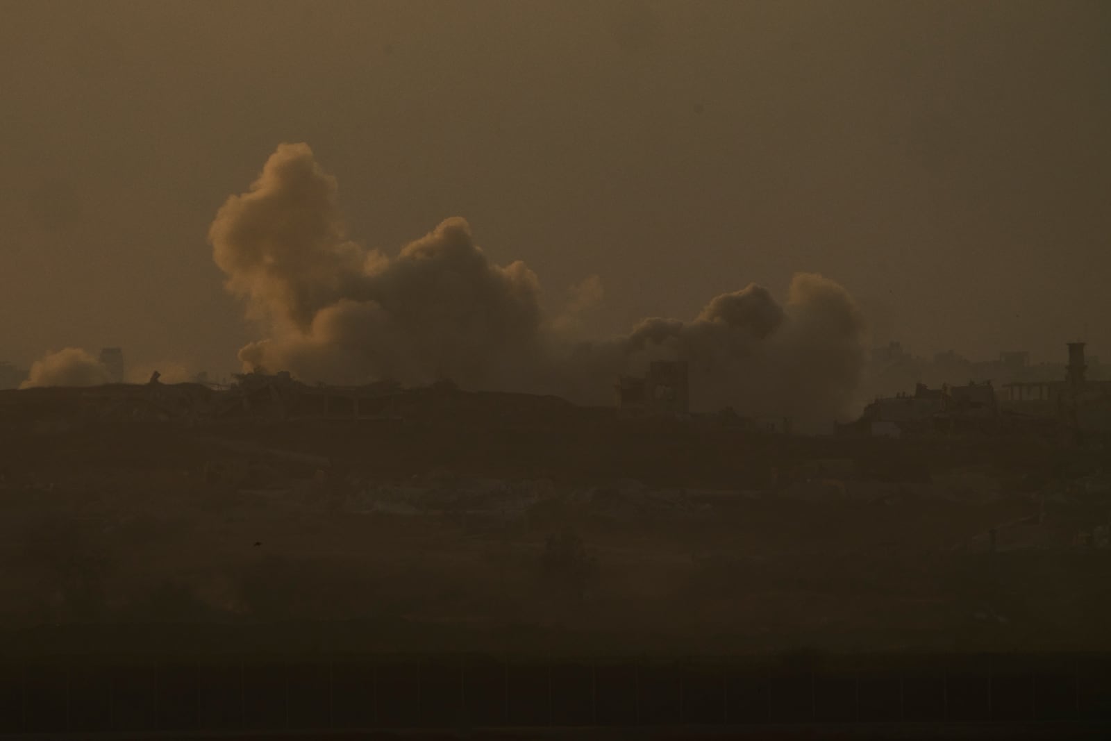 Smoke from Israeli bombardment billows over the Gaza Strip, seen from southern Israel, Wednesday, June 11, 2025. (AP Photo/Ariel Schalit)