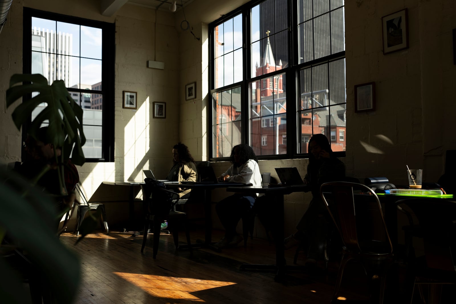 Patrons sit at Fuego Coffee Roasters, Saturday, March 22, 2025, in Rochester, N.Y. (Max Conway via AP)