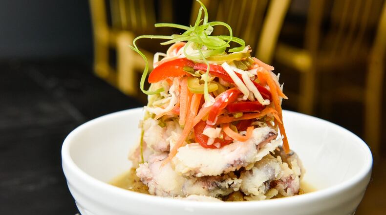 Tano Bistro is now open at 150 Riverfront Plaza on the corner of Dayton Street and Riverfront Plaza in the first floor of The Marcum, a new mixed-used development, in Hamilton.
Tano Bistros Hamilton location, a 100-seat dining space, will initially open at 4 for but dinner but may expand hours in the future. This is their Mofongo with crispy octopus, smoked pork belly, plantain, chicken bone broth and pikliz. NICK GRAHAM/STAFF