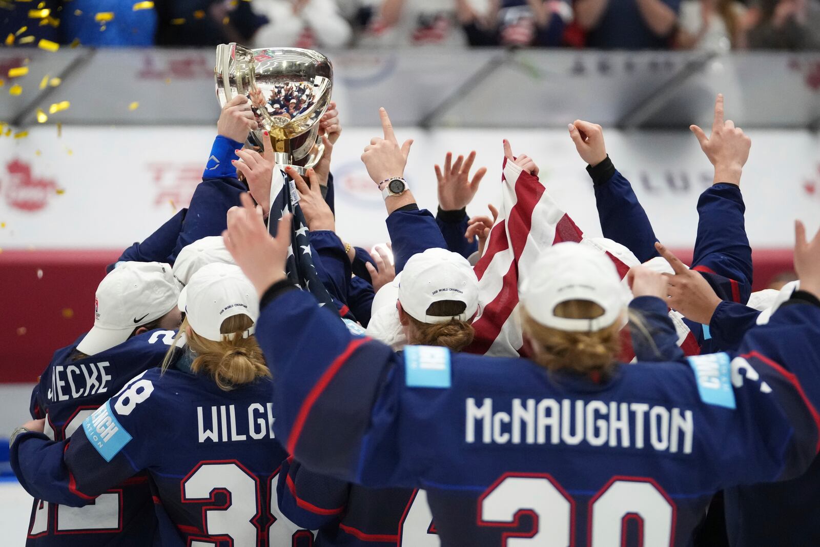 United states players celebrate with a trophy after the gold medal match between Canada and United States at the Women's Ice Hockey Championships in Ceske Budejovice, Czech Republic, Sunday, April 20, 2025. (AP Photo/Petr David Josek)