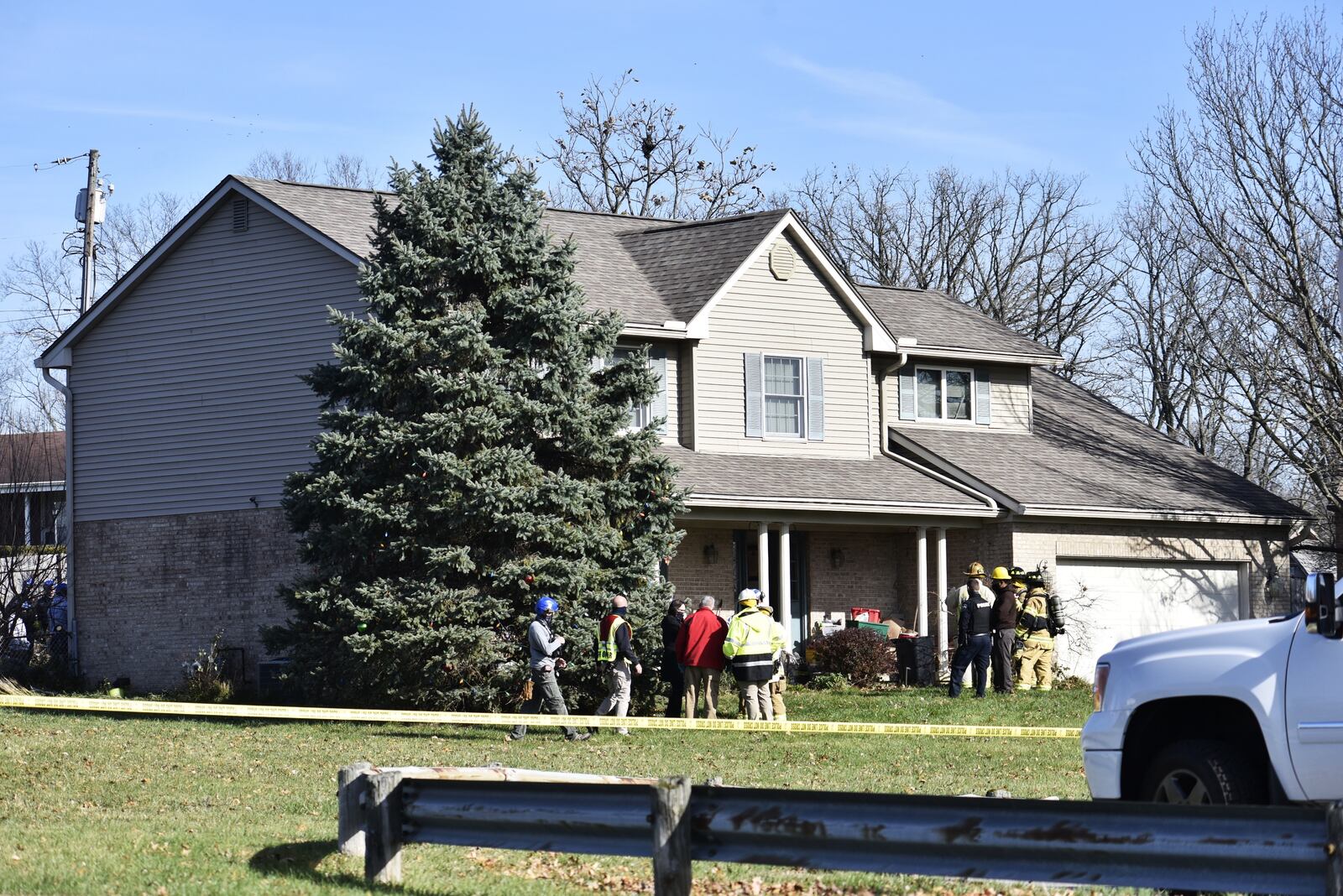 Emergency units work to remove a truck that slammed into a Monroe house this morning NICK GRAHAM/STAFF