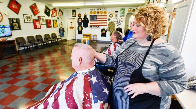 Terra Combs cuts Ken Campbell’s hair at Dixie chicks Barber Shop Tuesday, Oct. 15 on Pleasant Avenue in Fairfield. Combs has purchased Dixie Chicks Barber Shop after working there for several years. NICK GRAHAM/STAFF