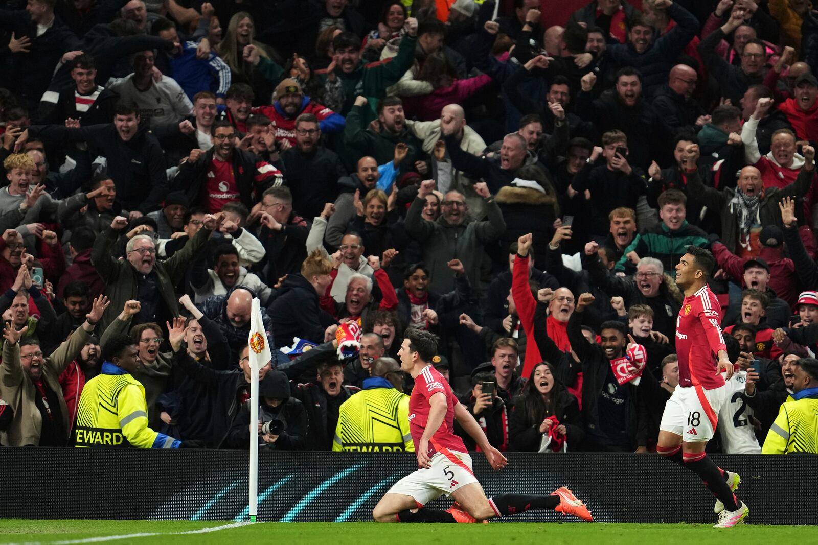Manchester United's Harry Maguire, left, celebrates with team mates after his side's fifth goal during the Europa League quarter final second leg soccer match between Manchester United and Olympique Lyon in Manchester, Britain, Thursday, April 17, 2025. (AP Photo/Jon Super)