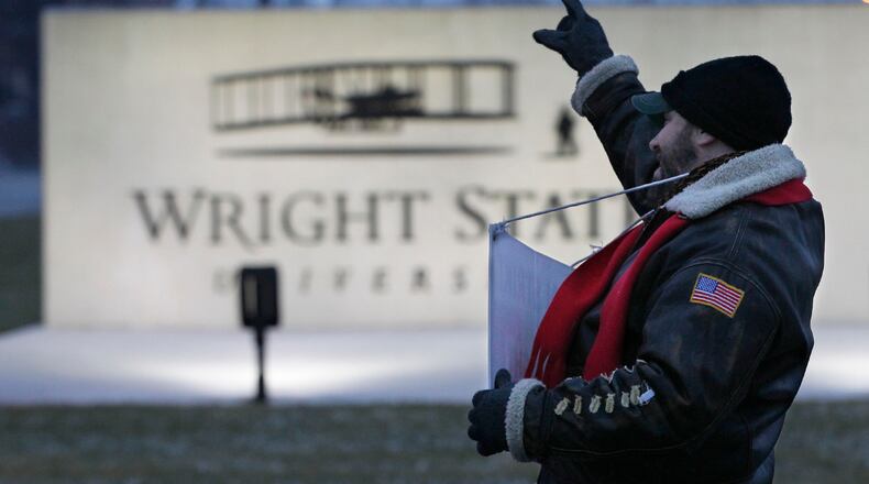 David Castellano, production manager and associate professor of Theater Design and Technology, acknowledges a honking car in front of Wright State. Striking members of Wright State University’s faculty union continued to picket on Thursday, the third day of the strike. Most classes continued to operate with some consolidated, some taught by substitutes, and others taught online. TY GREENLEES / STAFF