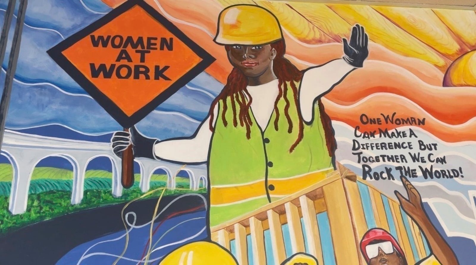 A mural by artist Tene Smith is seen near the entrance of Chicago Women in Trades, a nonprofit dedicated to training and retaining women in the skilled construction trades, is shown on April 1, 2025, at the facility in Chicago. (Tene Smith via AP)