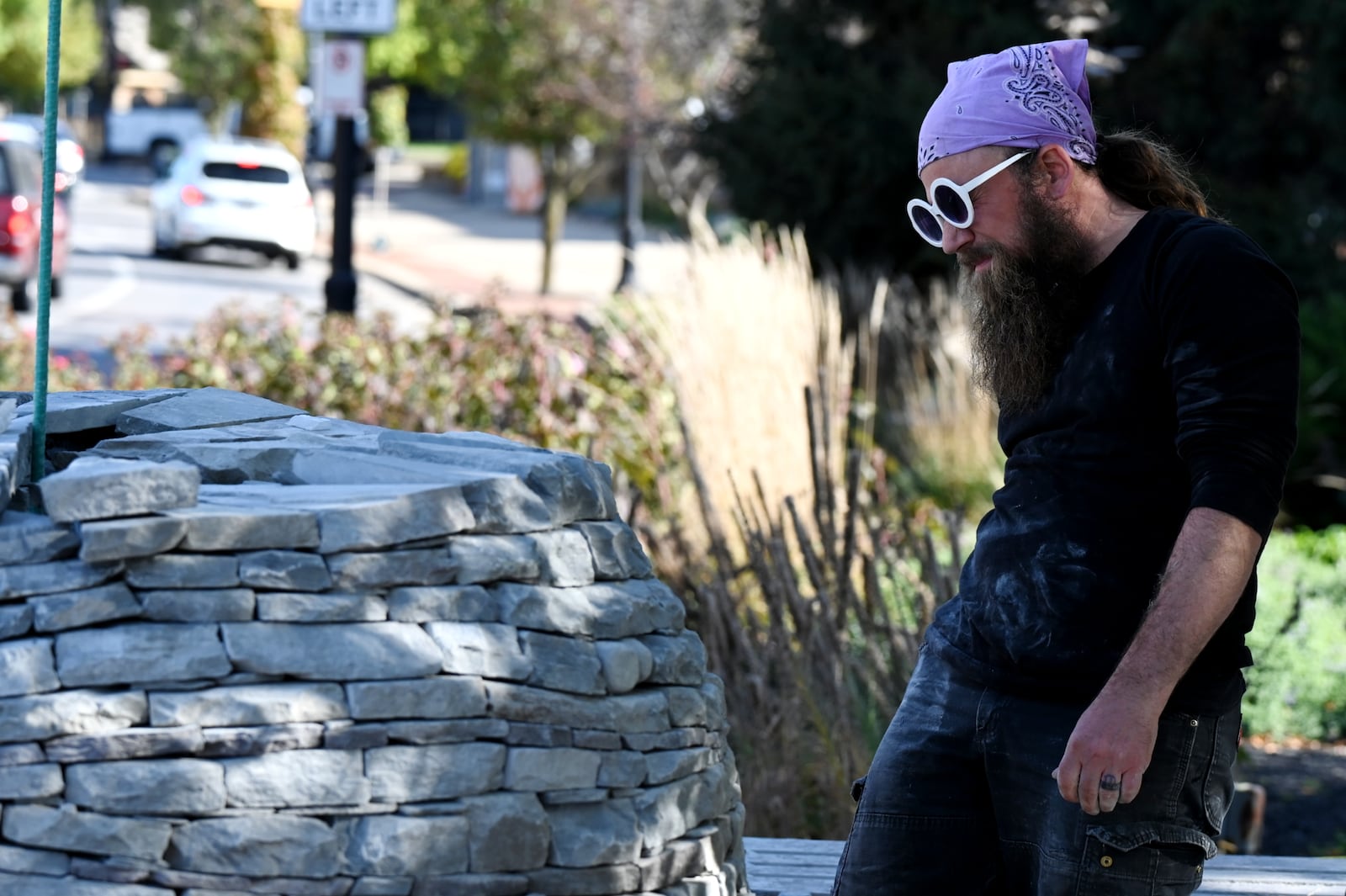 Devin Devine is a sculptor charged with creating a piece of art outside of the Well House Hotel in downtown Hamilton. It's the first piece commissioned by the City of Sculpture in a couple of years. Pictured is Devine working on the art installation on Oct. 24, 2025. MICHAEL D. PITMAN/STAFF
