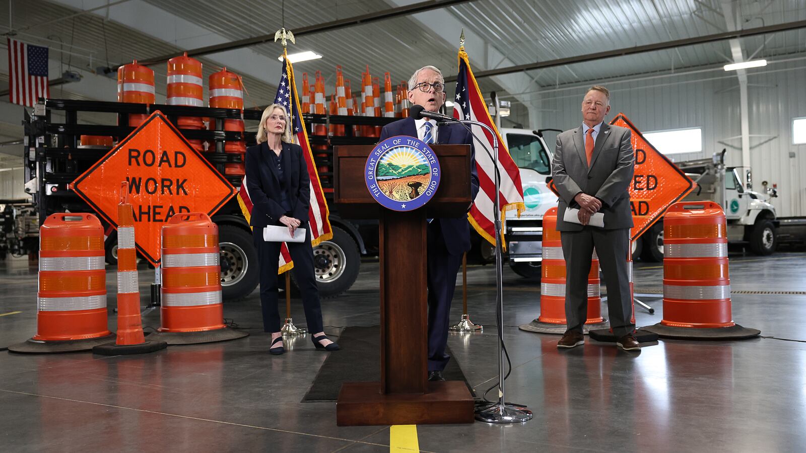 Gov. Mike DeWine speaks during a news conference as Ohio Department of Transportation Director Pamela Boratyn, left, and District Seven Deputy Director Bud O'Brien watch Thursday, April 3, 2025, at ODOT's facility in Moraine. BRYANT BILLING / STAFF