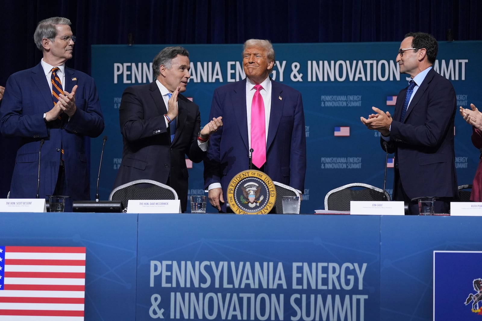 President Donald Trump arrives to speak at the "Inaugural Pennsylvania Energy and Innovation Event" at Carnegie Mellon University, Tuesday, July 15, 2025, in Pittsburgh. Standing with the President are from left, Treasury Secretary Scott Bessent, Sen. Dave McCormick, R-Pa., Trump and Jon Gray, President and Chief Operating Officer, Blackstone. (AP Photo/Evan Vucci)