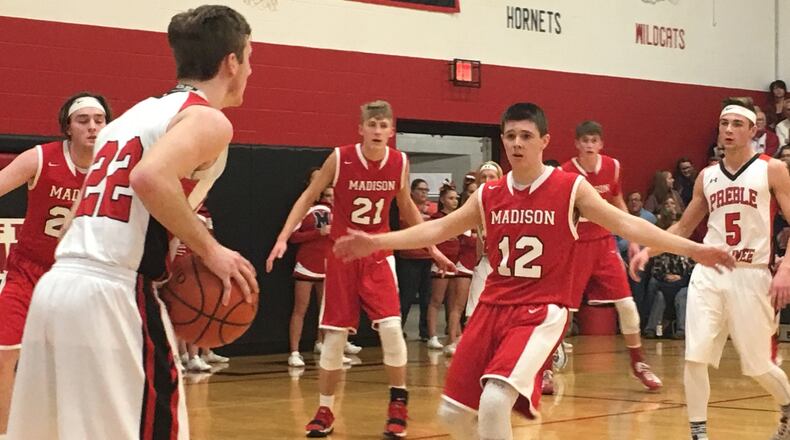 Madison’s Cameron Morgan (12) applies some defensive pressure to Preble Shawnee’s Austin Moore (22) during a game Feb. 9, 2018, at Shawnee. The visiting Mohawks won 50-45. RICK CASSANO/STAFF