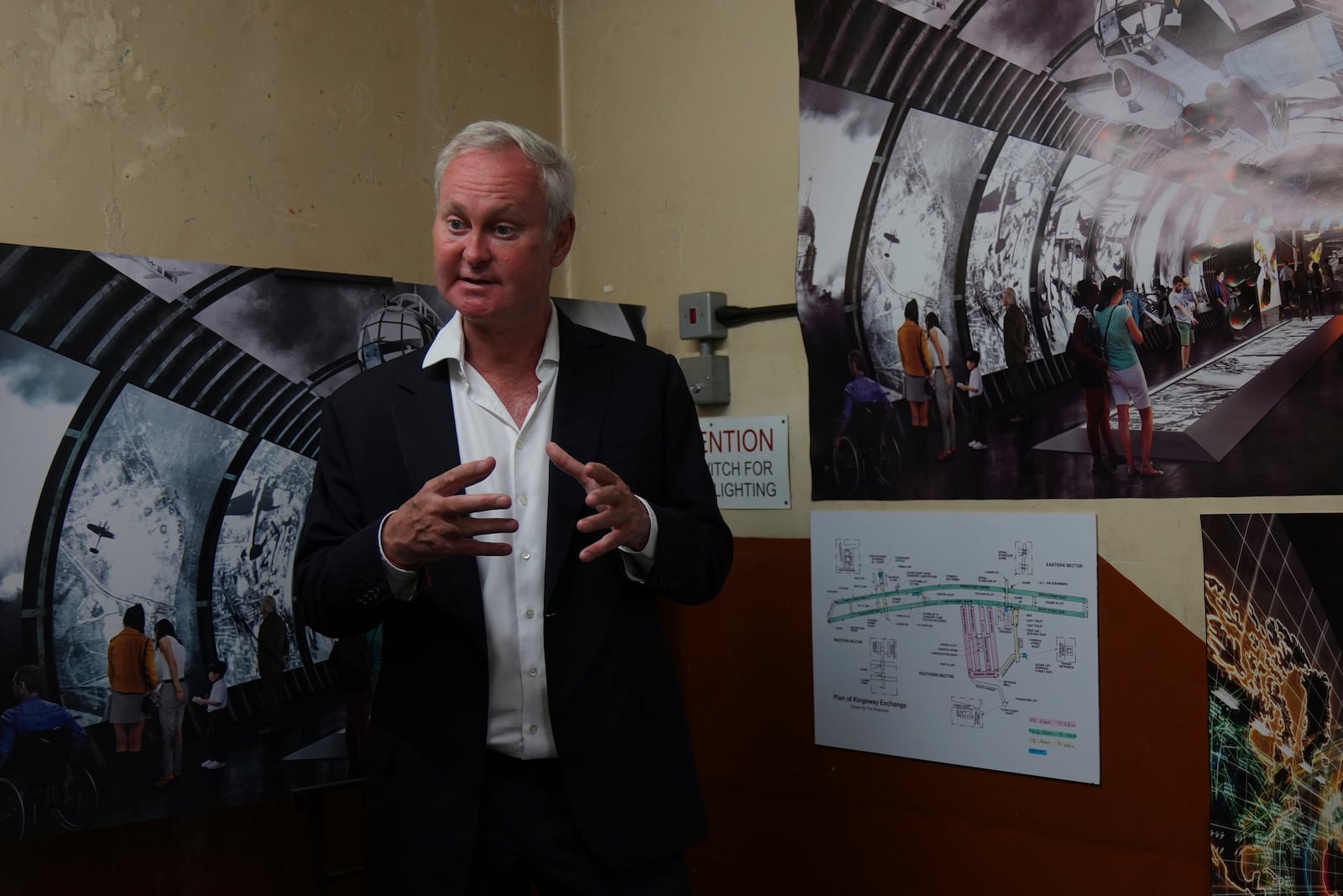 Angus Murray, CEO of The London Tunnels, gestures as he shows photos and diagrams relating to the history of the tunnels speaking during a press tour in London, Thursday, June 19, 2025. (AP Photo/Joanna Chan)
