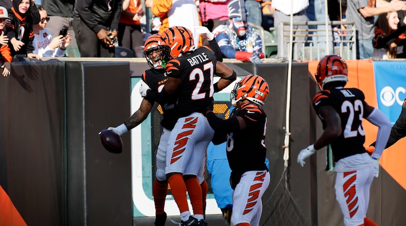 Cincinnati Bengals safety Geno Stone, left, celebrates with teammates after returning an interception for a touchdown during the first half of an NFL football game against the New England Patriots, Sunday, Nov. 23, 2025, in Cincinnati. (AP Photo/Jay LaPrete)