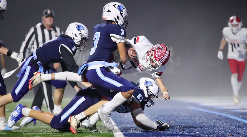 Cedarville High School senior quarterback Will Mossing barrels through three Cincinnati Country Day defenders into the end zone during their Division VII, Region 28 quarterfinal game on Friday night at the Brian J. Bortz Family Stadium in Indian Hill. The Indians won 49-21. CONTRIBUTED PHOTO