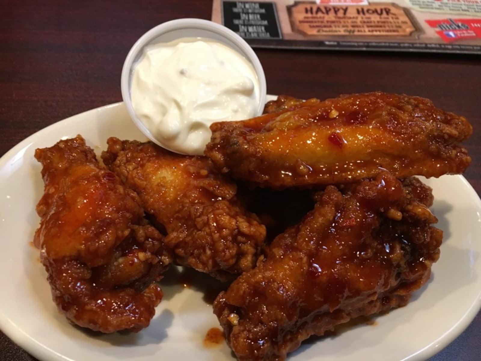 Nick's hand flours all of its wings and has a line of sauces that pack a punch. JIM INGRAM/STAFF