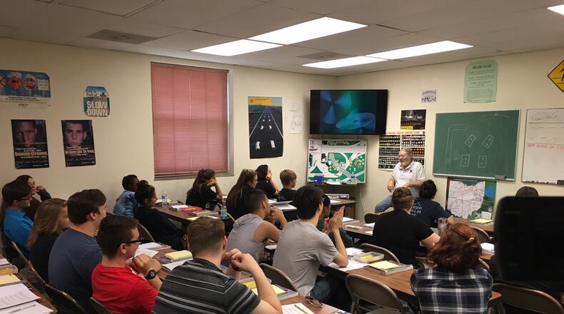 Students sit in an area driver's education class.