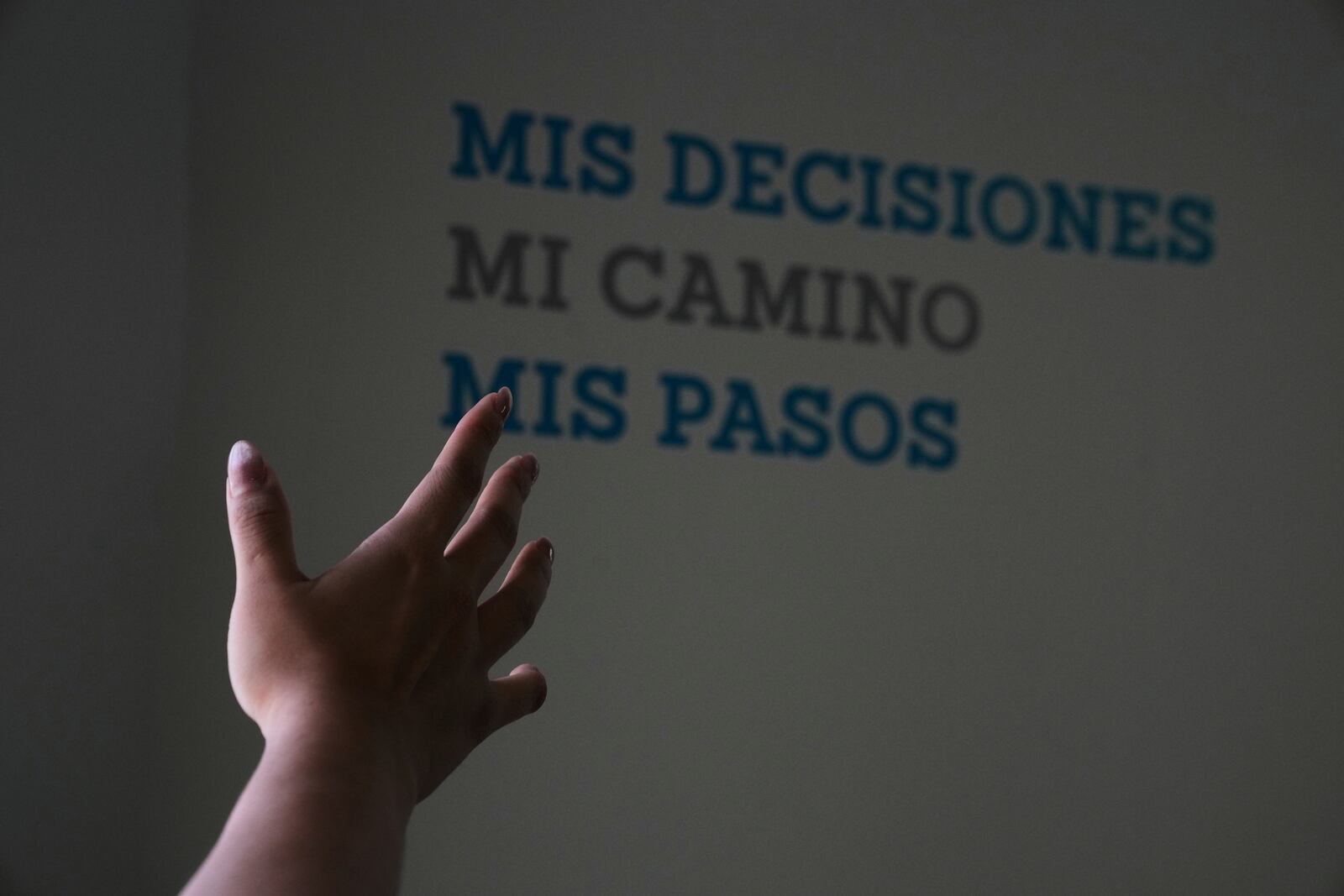 A health worker gestures towards a message that reads in Spanish; "My decisions, my road, my steps" during a tour of the MSI Foundation, an organization that offers information and help to women seeking abortions, in Mexico City, Thursday, May 8, 2025. (AP Photo/Marco Ugarte)