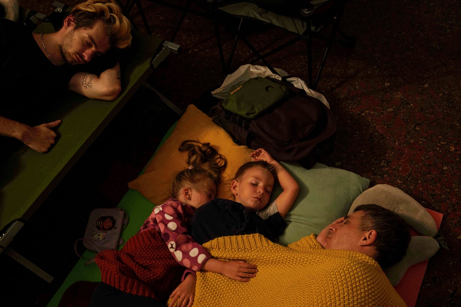 FILE - A family sleeps in a metro station as they take cover during a Russian attack on Kyiv, Ukraine, on July 10, 2025. (AP Photo/Evgeniy Maloletka, File)