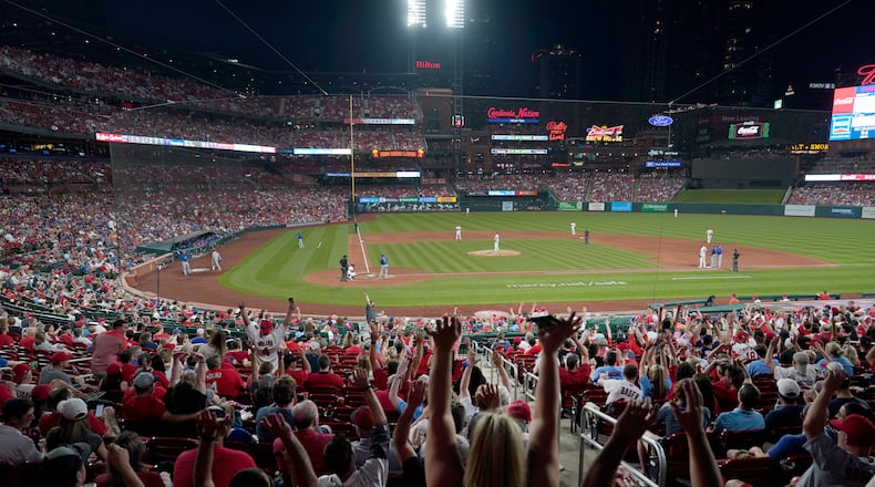 Fans do The Wave as the St. Louis Cardinals play the Chicago Cubs during the sixth inning of a baseball game Friday, May 21, 2021, in St. Louis. Capacity inside Busch Stadium has been increased for the series and and will be increased to capacity starting June 14 as coronavirus restrictions are lifted. (AP Photo/Jeff Roberson)