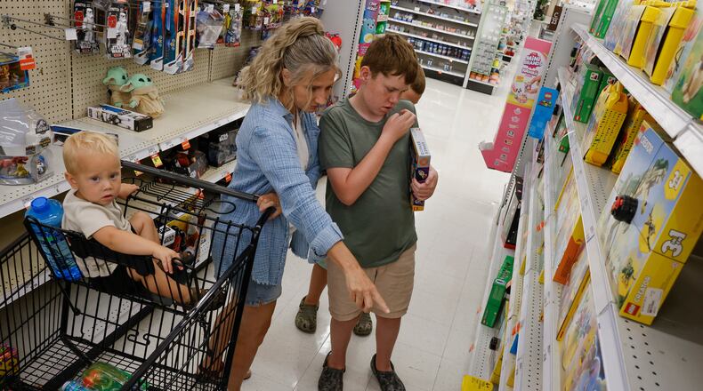 Melanie Stewart shops with her grandkids Archer McEwen, 1, Christopher McEwen, 12, and Jaxon McEwen, 8, at Meijer Wednesday, July 23, 2025 in Middletown. Ohio’s upcoming sales tax holiday continues to grow the ways people can save and, this year, the amount of time in which they can do it. The sales tax-free time runs from Aug. 1 to Aug. 14. NICK GRAHAM/STAFF