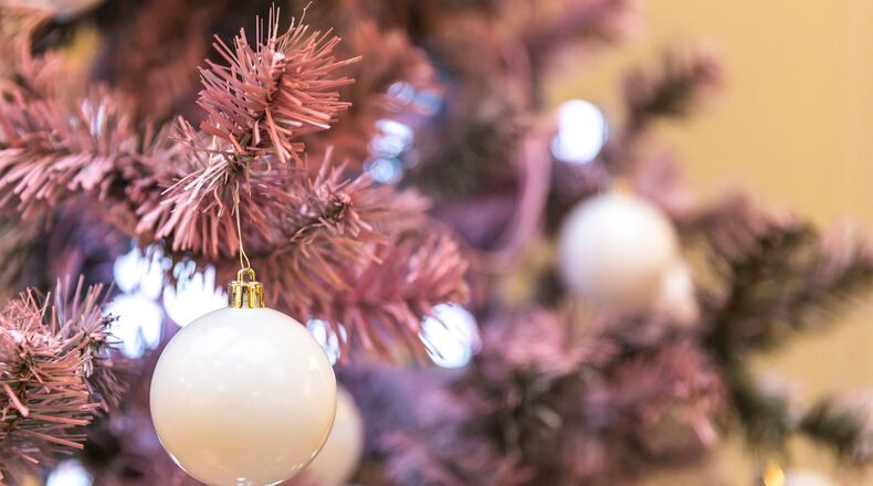 Pink holiday decor is popular this season as some are purchasing pink artificial Christmas trees and decorating with more glam. iSTOCK/COX