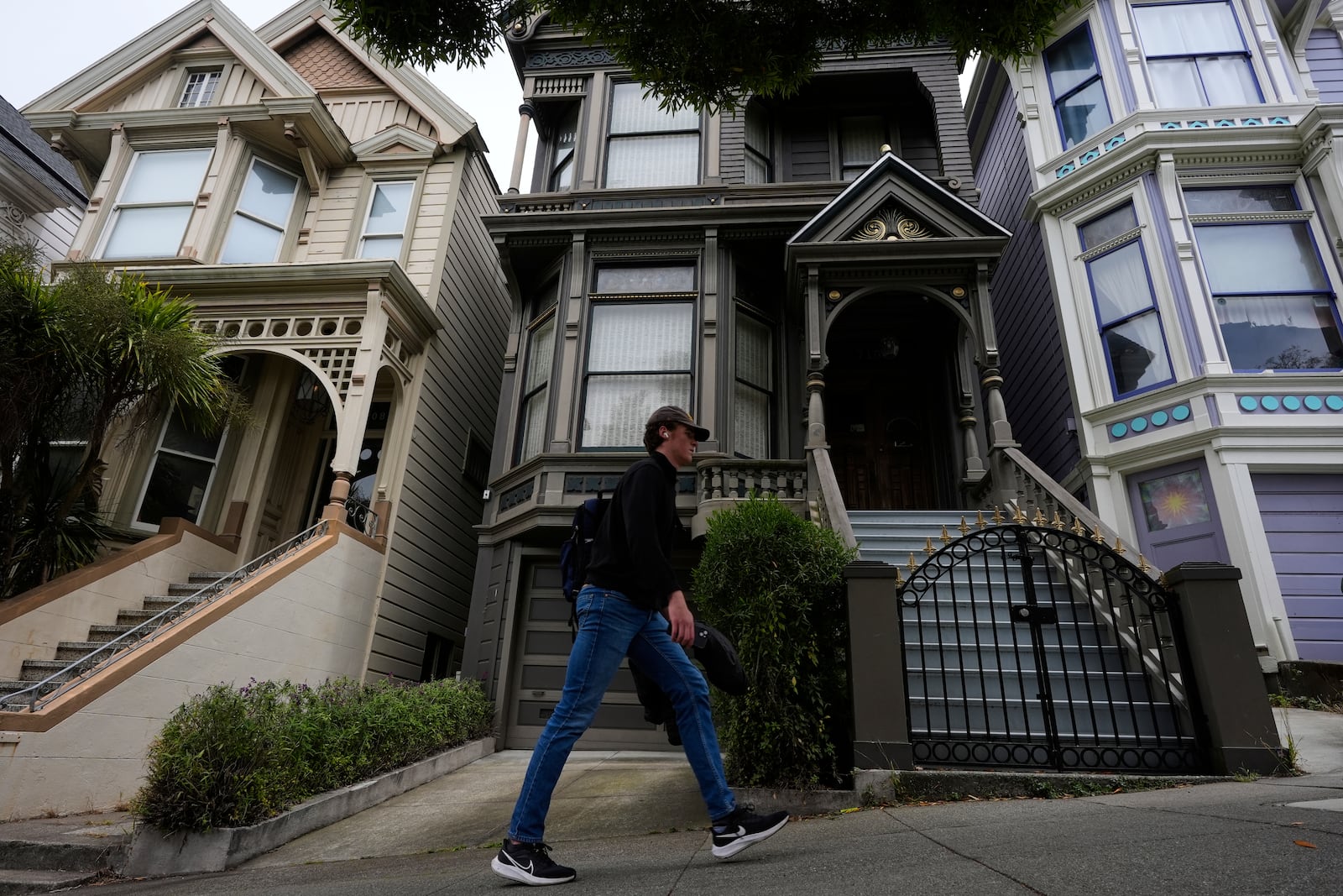 A man walks past the house where the original members of the Grateful Dead music group lived in San Francisco, Saturday, July 19, 2025. (AP Photo/Godofredo A. Vasquez)