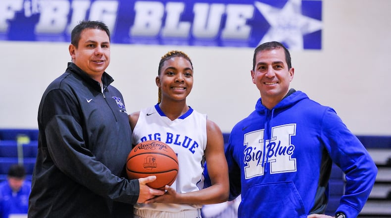 Hamilton’s CiCi Riggins (middle) stands with Hamilton athletic director Todd Grimm (left) and principal John Wilhelm to be honored as the school’s all-time leading scorer in girls basketball during Thursday night’s game against Northwest at the Hamilton Freshman School. The visiting Knights won 62-51. NICK GRAHAM/STAFF
