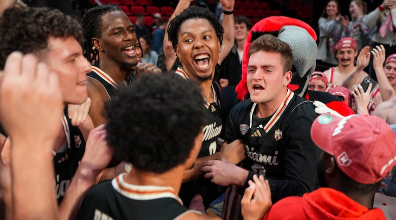 Miami (Ohio) players celebrate with fans following an NCAA college basketball game against Bowling Green, Friday, Feb. 20, 2026, in Oxford, Ohio. (AP Photo/Jeff Dean)