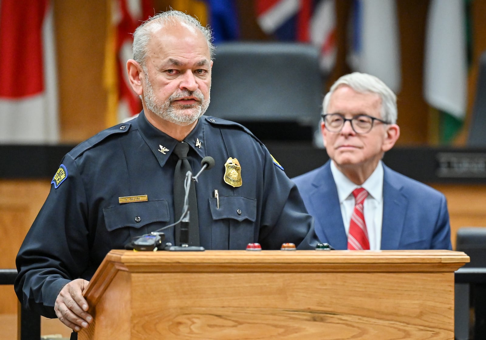 Dayton police Chief Kamran Afzal speaks while Gov. Mike DeWine listens during a news conference on Monday, Dec. 1 at Dayton City Commission Office. Afzal said violent crime in Dayton is down about 18 percent this year. BRYANT BILLING/STAFF