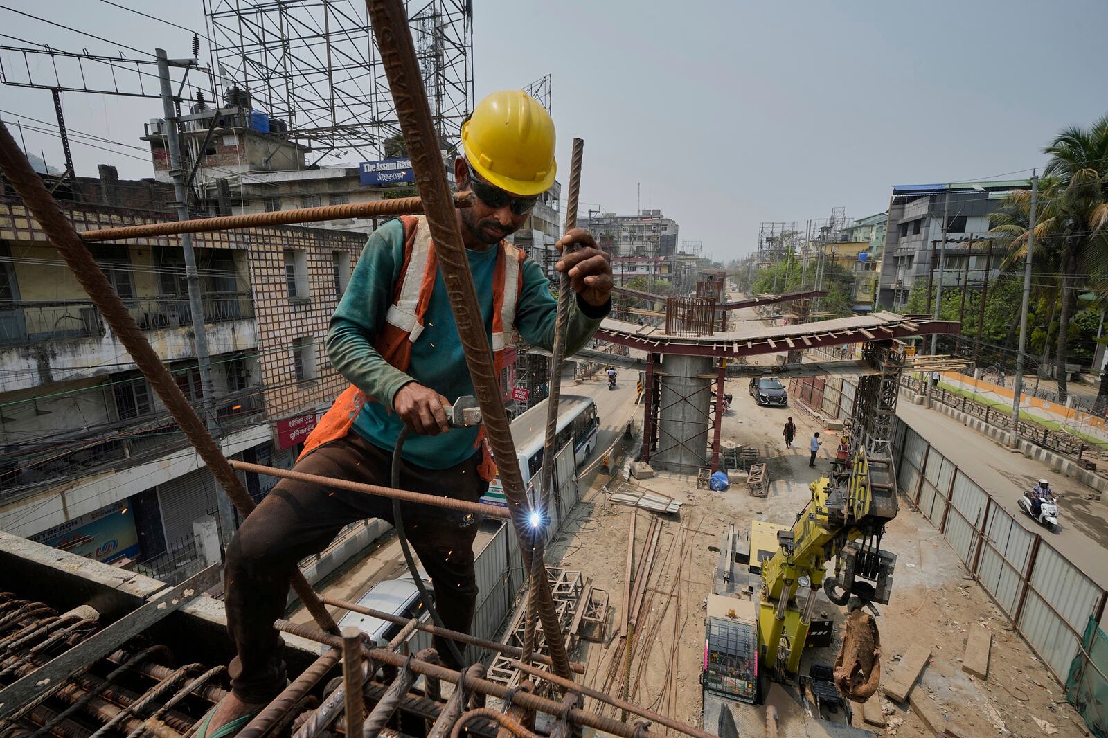 A labourer works on the construction of a bridge in Guwahati, India, Tuesday, April 8, 2025. (AP Photo/Anupam Nath)