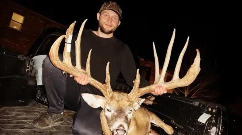 Hunter Christopher "CJ" Alexander poses with the deer he took in Clinton County. The deer's rack was green-scored at a typical 206 7/8 inches, which would push it 5 inches past the Ohio record. Photo provided by Sierra Smith.