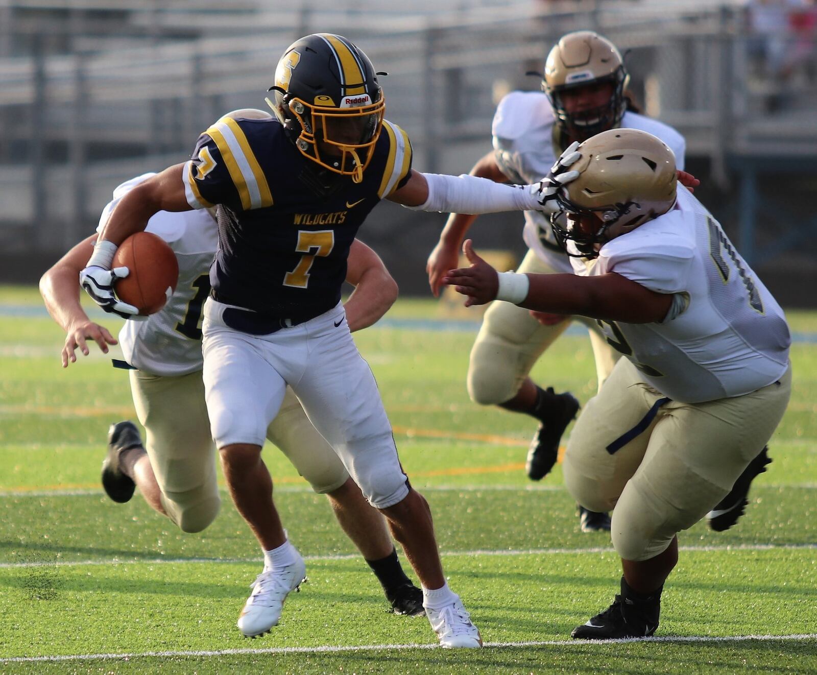 Springfield’s Michael Brown-Stephens stiff-arms a defender during the Wildcats’ 20-14 victory over Lancaster at Evans Stadium in Springfield last Friday. CONTRIBUTED PHOTO BY MICHAEL COOPER