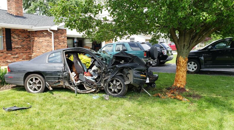 Neighbors say a car that slammed into a tree in the front yard of 860 North Garver Road in Monroe Sunday, May 26, 2019, is just the latest in a series of vehicles that routinely speed down the rural roadway. The crash injured two people, both of whom were taken to Atrium Medical Center. ERIC SCHWARTZBERG/STAFF