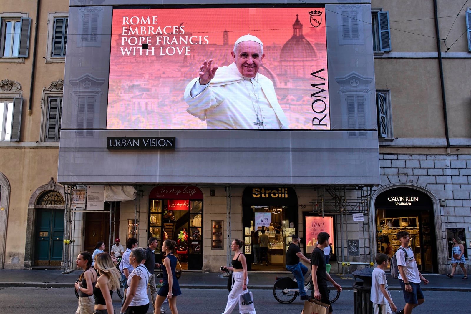 A street screen dedicated to Pope Francis reads "Rome hugs Francis with Love" in downtown Rome, Friday, May 2, 2025. (AP Photo/Bernat Armangue)