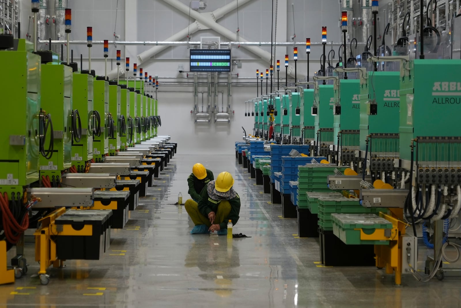 Workers scrub the floor at Lego factory in Binh Duong, Vietnam Wednesday, April 2, 2025. (AP Photo/Hau Dinh)