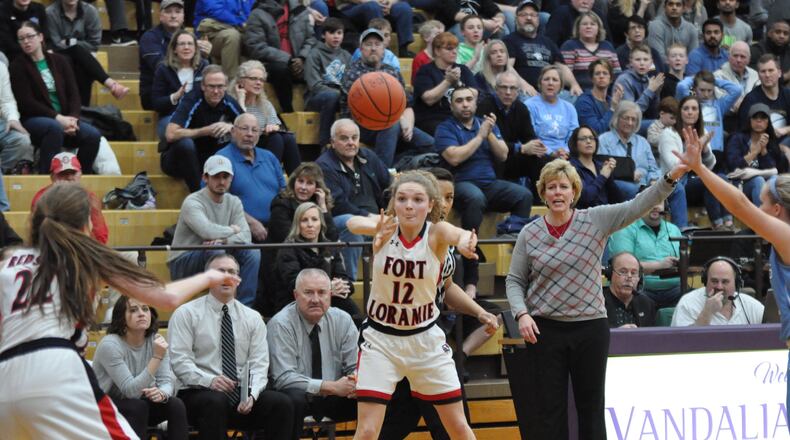 Fort Loramie junior Kennedi Gephart passes the ball to Kenzie Hoelscher as Redskins’ head coach Carla Siegel looks during Loramie’s 47-39 victory against Legacy Christian in a Division IV regional semifinal contest at Butler High School March 7, 2019. Nick Dudukovich/CONTRIBUTED